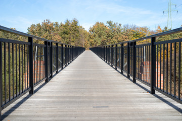 A bridge made of planks in central europe. Crossing the river built on a lattice from the narrow-gauge railway bridge.