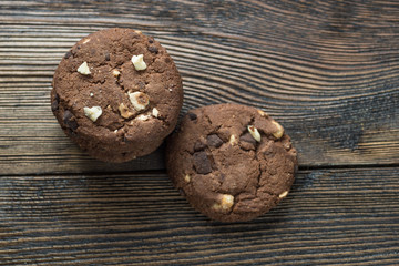 Soft dark chocolate brownie cookies on wood