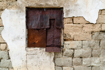 rusty sheets of metal securing a window