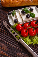 A piece of feta cheese on a wooden rustic background