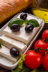 A piece of feta cheese on a wooden rustic background