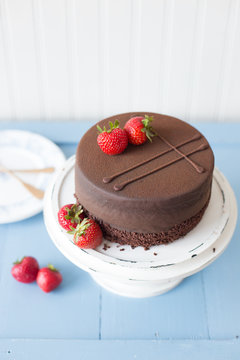 Whole chocolate cake with strawberries