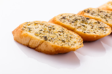 fragrant garlic bread on a white acrylic background