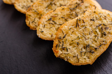 fragrant garlic bread on a dark stone plate