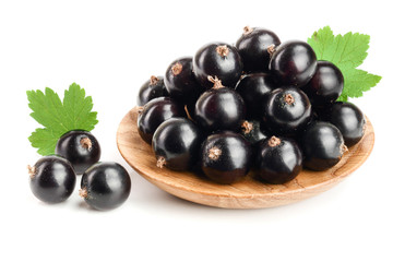 black currant with leaf in wooden bowl isolated on white background