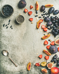Healthy seasonal fall breakfast variety. Flat-lay of Greek yogurt, fresh fruit, chia seeds bowl over grey concrete background, top view, copy space, vertical composition. Clean eating, dieting food