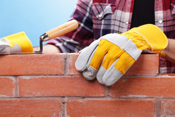 Builder working on a brick wall