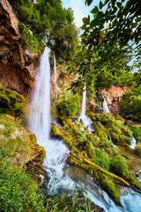 Fototapeta na wymiar Waterfalls Three Flowing in Green Fields