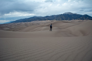 Person exploring sand dunes - 228755881