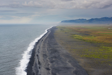 Aerial Panorama over Black Sand Beach, Mountains, and Ocean in Iceland