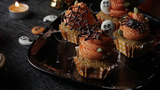 Fancy Halloween food Party Table with Pumpkin Cupcake Muffin and cookies.
