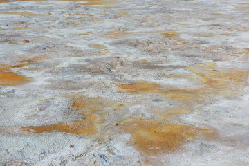 Geothermal area at Hverir, Iceland. Mud pots are boiling, the ground is multicolored and cracked.