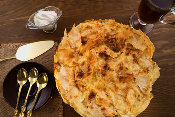 Sweet dessert made of dough and baked Golden brown, spoon and paddle portions, wooden background.