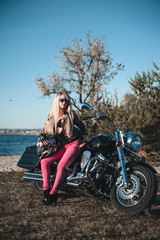 Obraz premium Beautiful woman on motorcycle outdoor. 
