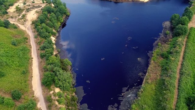 Aerial view of a lake in Pomezia near Rome. Country green and trees. Lake solfatara  
