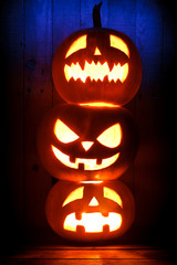 Three Halloween pumpkins on dark background © Devist
