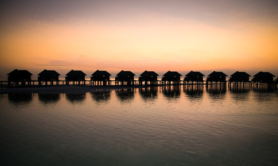  Luxury water lodges in sunset, Maldives.