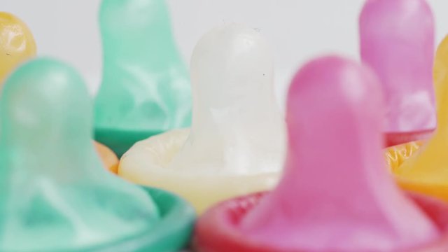 Macro shot of colorful condoms in the studio on white background. Shot in 4k resolution