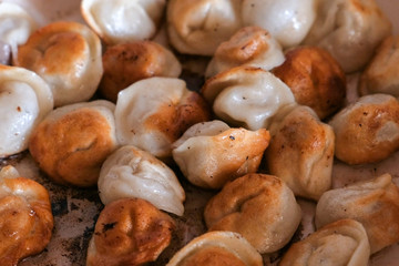 Dumplings frying on a pan. Close-up on table.