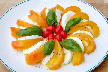 Image of Mozzarella Italian salad food make from Tomatoes, basil leaves, Balsamic and olive oil seasoning with salt and peppers can be serve for first course or salad dish accompany with main dish. 