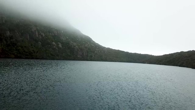 A drone shot hovering over tarn in the mountains of Tasmania.
