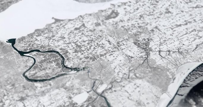 Very high-altitude circular tracking shot of a frozen Erie, Ontario, Canada with tilt-shift effect. Reversible. Elements of this image furnished by NASA. 