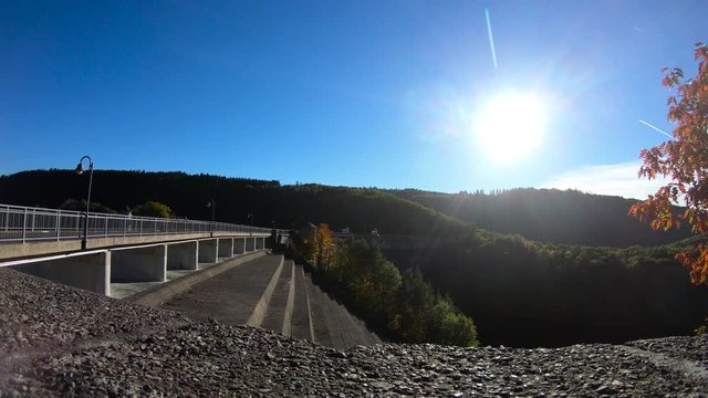 Time lapse of a dam in the Eifel with a low sun