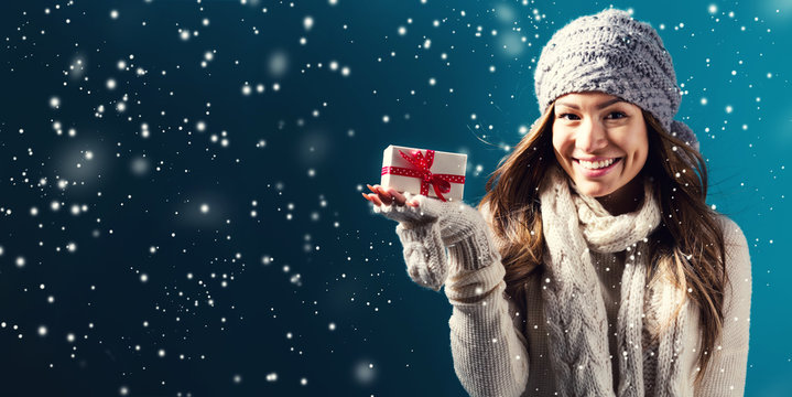 Happy Young Woman Holding A Christmas Present