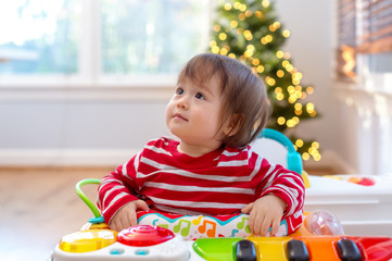 Toddler boy playing in his house around Christmas time