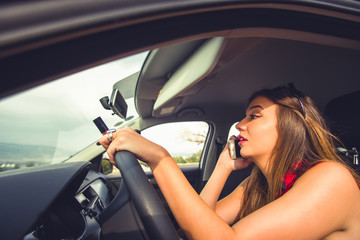 Woman in risk driving holding and talking at her cellphone