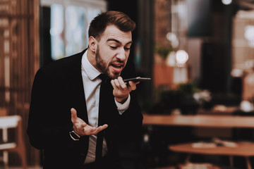 Business Suit. Talking Loudly on Phone. Workplace.