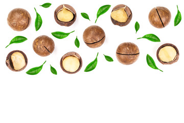 Shelled and unshelled macadamia nuts with leaves isolated on white background with copy space for your text. Top view. Flat lay pattern