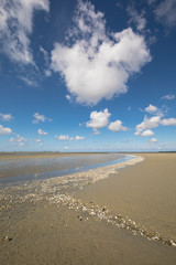Litlle river flowing on the beach into sea, Somme Bay, Picardy, France.