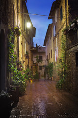 Fototapeta na wymiar Old European city Pienza street at rainy night, Tuscany, Italy