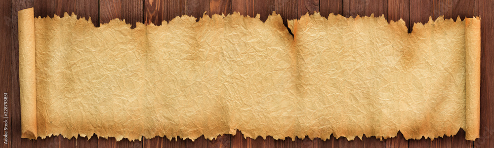 Poster panoramic background of old paper. unfolded scroll on the table