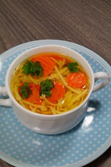 Hot traditional chicken soup in a white dish ,served at Christmas dinner
