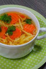 Hot traditional chicken soup in a white dish ,served at Christmas dinner

