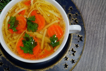 Hot traditional chicken soup in a white dish ,served at Christmas dinner
