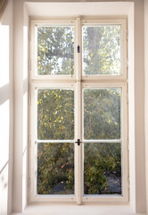 Fototapeta na wymiar White old fashioned wooden window on white wall