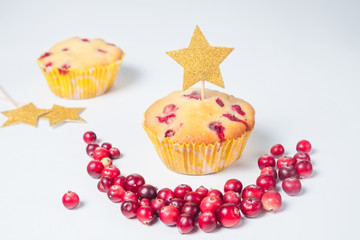 cranberry cupcakes on a white table with a golden star topper