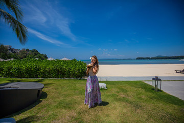 Girl with coconut at the tropical beach