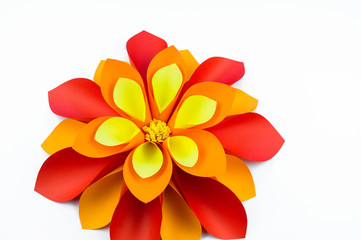 A large flower made of paper orange-red yellow colors