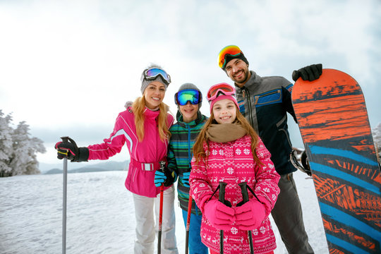 family enjoying winter vacations in mountains. Ski, Sun, Snow and fun