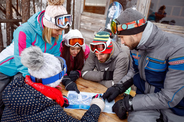 Group of skiers look on map