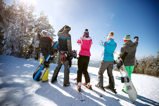 Skiers on the top of the mountain, back view