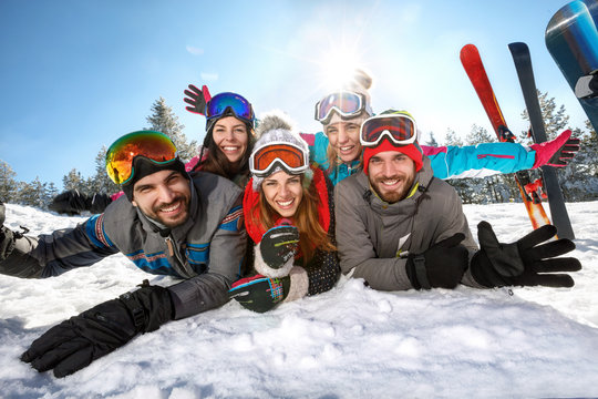 Happy skiers together on winter vacation