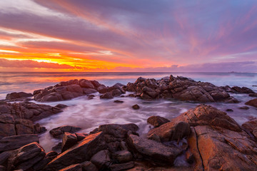A beautiful sunset over rocky coastline at Sugarloaf Rock near Dunsborough, Western Australia.