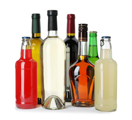 Bottles with different alcoholic drinks on white background