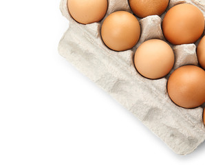 Carton of raw chicken eggs on white background, top view