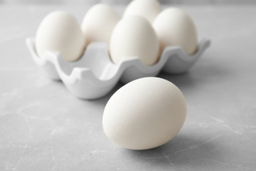Raw chicken egg on light background, closeup